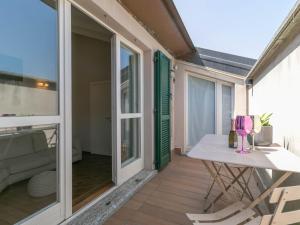 a small balcony with a table and chairs on it at Mamma Ciccia Holiday Home - Cozy Attic in Galbiate