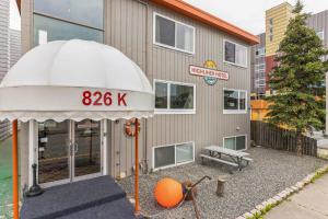 a building with an umbrella in front of it at Highliner Hotel - Queen Suites in Anchorage