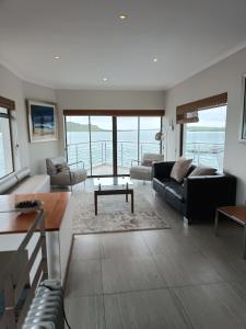 a living room with a couch and a table at Sunset Villa in Langebaan