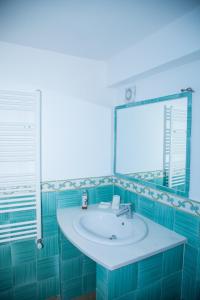 a bathroom with a sink and a mirror at Arcadia Case e Vacanze in Ischia