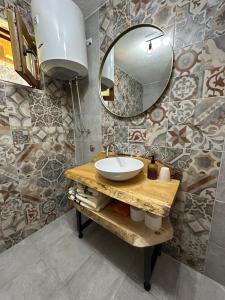 a bathroom with a sink and a mirror at Apartmani nisicka oaza 2 in Ilijaš +10 photos