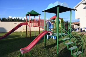 a playground with a red slide and a slideintend at Grand Kokino 