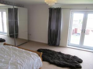 a bedroom with a bed and a large window at junction house in Stockton-on-Tees