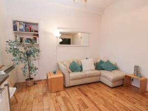 a living room with a couch and a table at Silverbells in Millport