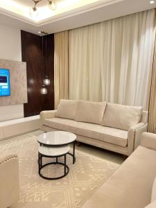a living room with a couch and a table at New apartment, two entrances in Riyadh