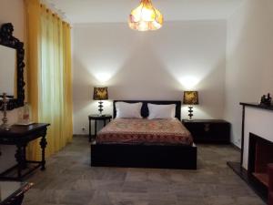 a bedroom with a bed and a chandelier at Alentejo Cante & Vinho in Ferreira do Alentejo
