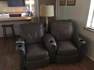 a pair of leather chairs in a living room at Grand Canyon 1bd Loft at Historic Wrigley Ranch-Suite with Horseback Riding, Hiking in Parks