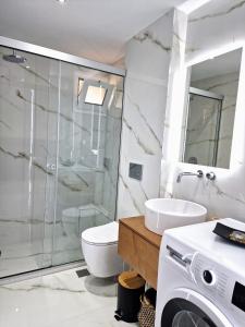 a bathroom with a shower toilet and a sink at Stelios House w Courtyard in Heraklio Town