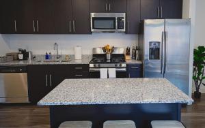 a kitchen with a counter top and a refrigerator at Kasa Downtown Salt Lake City in Salt Lake City