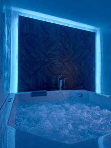 a bath tub with blue lighting in a bathroom at Holiday Home Korda in Čapljina +48 photos
