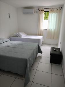Tempat tidur dalam kamar di Flat c/ 2 qts em Gravatá