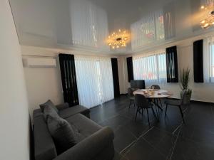 a living room with a couch and a table at Apartaments PopDan Residence by the Sea in Eforie Nord