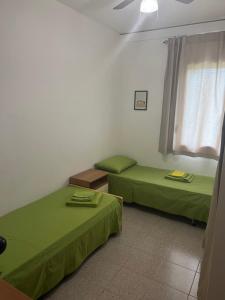 a room with two beds and a window at Villetta Indipendente Sardegna in Villaputzu