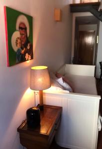 a small lamp on a table next to a bed at Casa do Mercador by Portus Alacer in Avis +24 photos