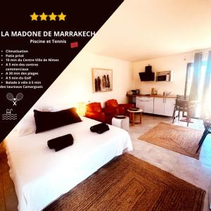 a bedroom with a white bed and a living room at Les Madones in Nîmes