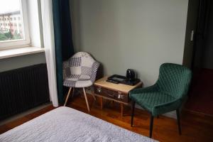 a bedroom with two chairs and a table and a bed at Open Doors Villa in Gdańsk +24 photos