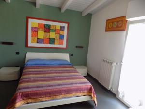 a bedroom with a bed and a painting on the wall at Attico Stazione - Montello 16 in Bari
