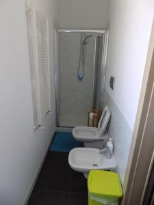a bathroom with two toilets and a shower and a sink at Attico Stazione - Montello 16 in Bari