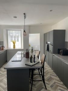 a kitchen with a table and chairs in a room at Fantastic home in Brightons, Falkirk. in Polmont