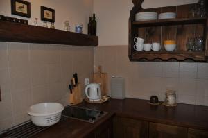 a kitchen with a sink and a counter top at Chata Balówka in Cisna