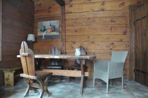 a wooden dining room with a table and chairs at Chata Balówka in Cisna