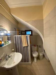 a bathroom with a sink and a toilet at villa kastanos in Amaliápoli