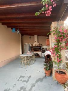 a patio with a table and chairs and a kitchen at villa kastanos in Amaliapoli