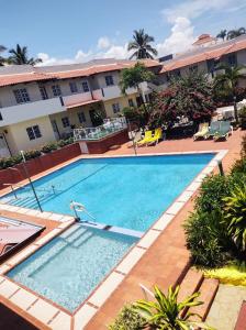 a large swimming pool in front of a hotel at Cozy Condo in Costambar Beach in San Felipe de Puerto Plata