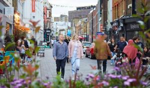 a man and woman walking down a city street at APlaceToStay Central London Apartment, Waterloo (UPT) in London +3 photos