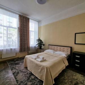 a bedroom with a bed with two towels on it at Cozy Apartment in Lviv