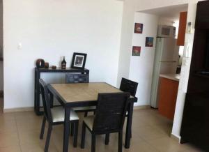 a dining room table and chairs in a kitchen at Twin Towers Acapulco (Caleta) in Acapulco