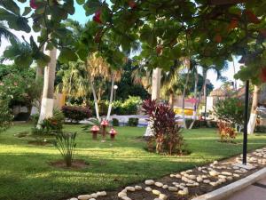 a park with trees and grass and a fire hydrant at Twin Towers Acapulco (Caleta) in Acapulco