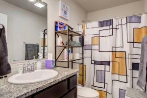 a bathroom with a sink and a toilet at Milano Lodge - Cozy Retreat in Lubbock