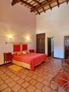 a bedroom with a large bed and a table and chairs at La Vaca Tranquila in San Carlos
