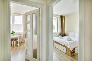 a bedroom with a bed and a table and a mirror at Delta Planet budget flat 2 guests in Varna City