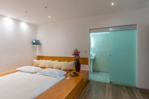 a bedroom with a large bed and a glass shower at Hotel Azul de Oaxaca in Oaxaca City