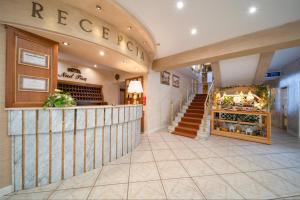a lobby of a store with a staircase and a store at Hotel Nad Pisą in Pisz