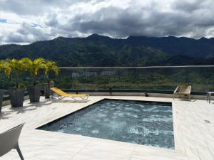 a swimming pool on a patio with mountains in the background at Edificio M-30 in Ibagué