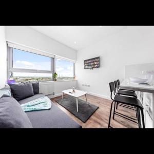 a living room with a couch and a table at London Delta's Gem 1BR 15 mins to London Bridge in Croydon