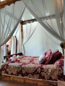 a bedroom with a bed with a canopy at Mi Atardecer en Tepoz, Hostal in Tepoztlán