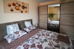 a bedroom with a bed and a mirror at City center in Zaječar