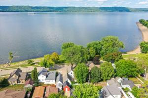 an aerial view of a house on the shore of a lake at Lake Pepin Waterfront Cottage - Steps to Beach! in Lake City