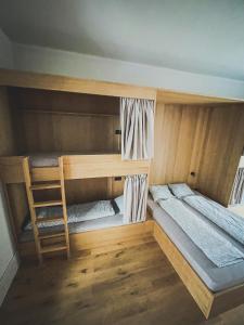 a room with two bunk beds and a ladder at Ruttner Suite in Veszprém