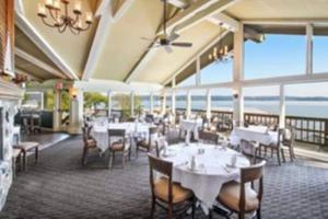 a dining room with tables and chairs and the ocean at Lake Geneva's resort amenities in Lake Geneva