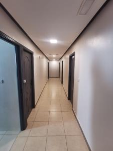 a hallway with doors and a tile floor at Dadar in Larache