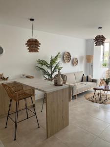 a living room with a table and a couch at Appartement Calpe ApoloV Ibiza Style in Calpe
