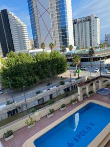 a swimming pool in a city with tall buildings at Appartement Calpe ApoloV Ibiza Style in Calpe