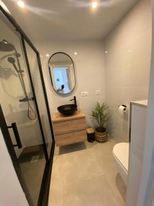 a bathroom with a sink and a mirror at Appartement Calpe ApoloV Ibiza Style in Calpe