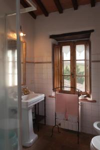 a bathroom with a sink and a window at VILLA DI GRAZIELLA in Montisi