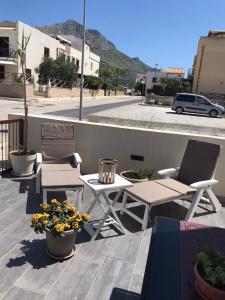 a patio with a table and two chairs and flowers at Casa Rosita in San Vito lo Capo